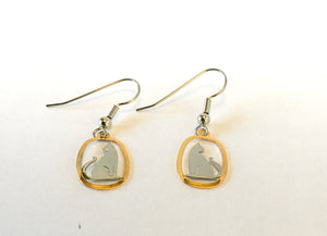Silver and gold cat earrings facing out
